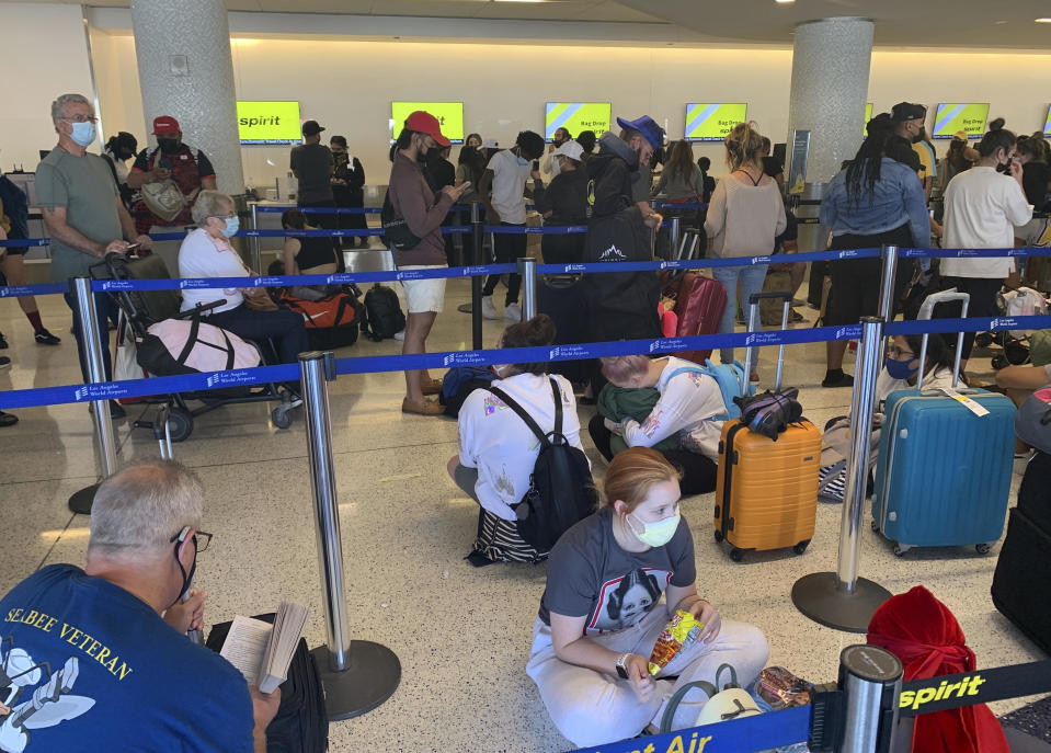 Passengers line up inside the Spirit Airlines terminal at Los Angeles International Airport on Tuesday, August 3, 2021. / Credit: Eugene Garcia / AP