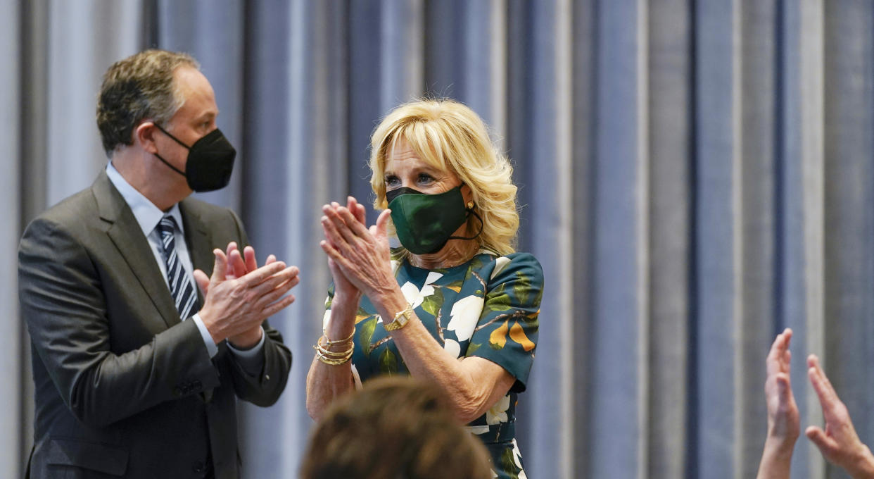 First lady Jill Biden and Second gentleman Doug Emhoff applaud after speaking and watching performances at the annual NGA Spouses Breakfast at the Kennedy Center in Washington, Monday, Jan. 31, 2022. (AP Photo/Carolyn Kaster)