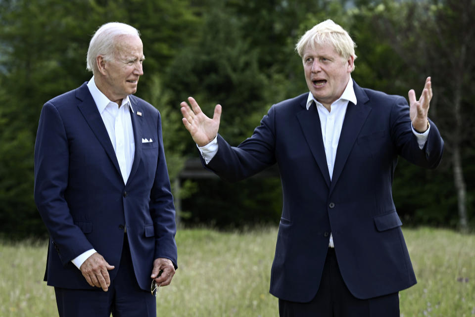 US President Joe Biden and Britain's Prime Minister Boris Johnson, right, chat as they gather for a group photo at Castle Elmau in Kruen, near Garmisch-Partenkirchen, Germany, on Sunday, June 26, 2022. The Group of Seven leading economic powers are meeting in Germany for their annual gathering Sunday through Tuesday. (Brendan Smialowski/Pool via AP)