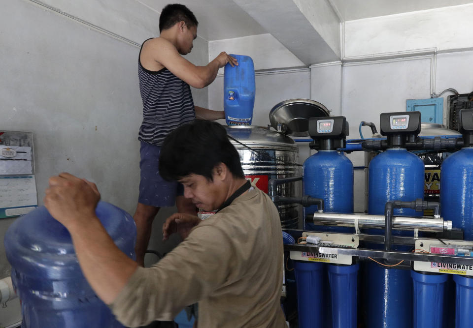 Workers prepare to filter water at a purifying station while they wait for the water supply to return at their area in Mandaluyong, metropolitan Manila, Philippines on Thursday, March 14, 2019. Aside from the daily line of residents waiting for water rations from trucks, many businesses like laundry shops, carwash and water purifying stations in some parts of metropolitan Manila have been affected by a water shortage from the Manila Water Company due to low levels at the La Mesa dam and the onset of El Nino which causes below normal rainfall conditions. (AP Photo/Aaron Favila)