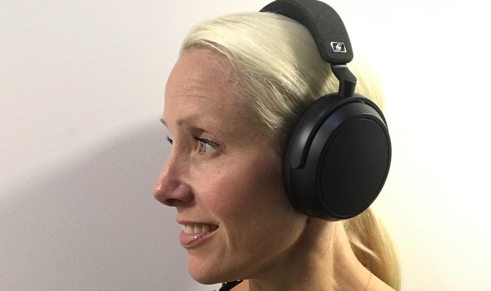 Senior staff writer Becky Scarrott wearing the Sennheiser Momentum 4 Wireless on white background