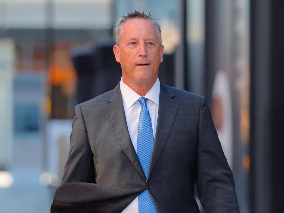Martin Fox, a former president of a private tennis academy in Texas, passes the federal courthouse before entering a plea in a nationwide college admissions cheating scheme in Boston, Massachusetts, U.S., November 15, 2019..JPG