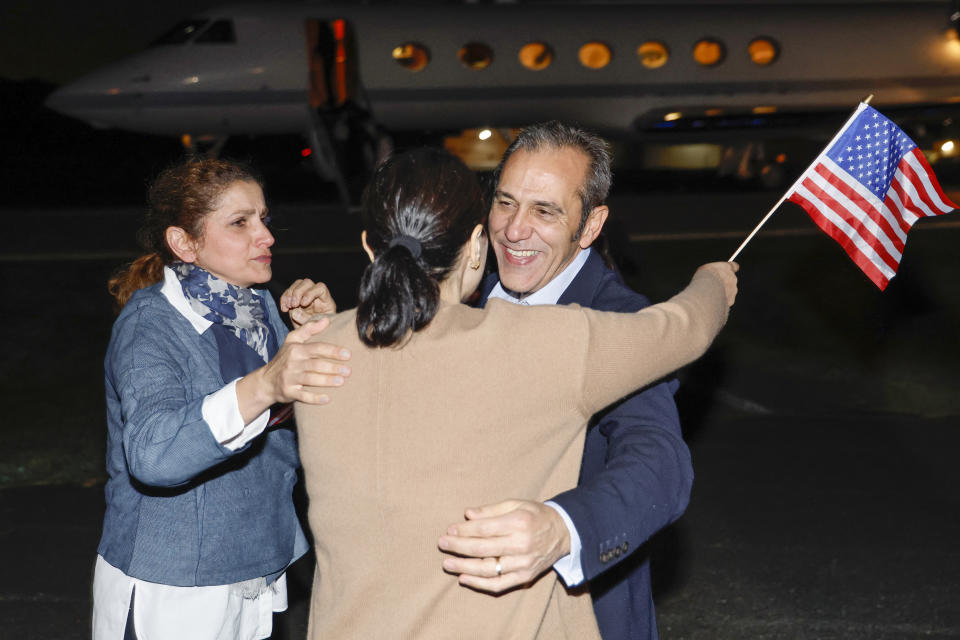 Family members embrace freed American Emad Shargi after he and four fellow detainees were released in a prisoner swap deal between U.S and Iran, as he arrives at Davison Army Airfield, Tuesday, Sept. 19, 2023 at Fort Belvoir, Va. (Jonathan Ernst/Pool via AP)