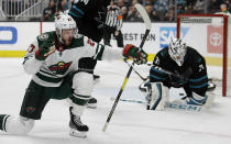 Minnesota Wild forward Alex Galchenyuk, left, celebrates after scoring a goal against San Jose Sharks' Martin Jones, right, in the second period of an NHL hockey game Thursday, March 5, 2020, in San Jose, Calif. (AP Photo/Ben Margot)