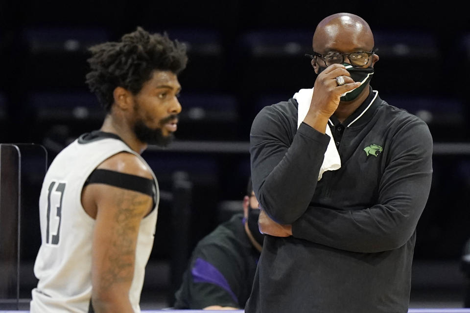 Chicago State head coach Lance Irvin, right, reacts as he looks at forward Aaris-Monte Bonds during the first half of an NCAA college basketball game against Northwestern in Evanston, Ill., Saturday, Dec. 5, 2020. (AP Photo/Nam Y. Huh)