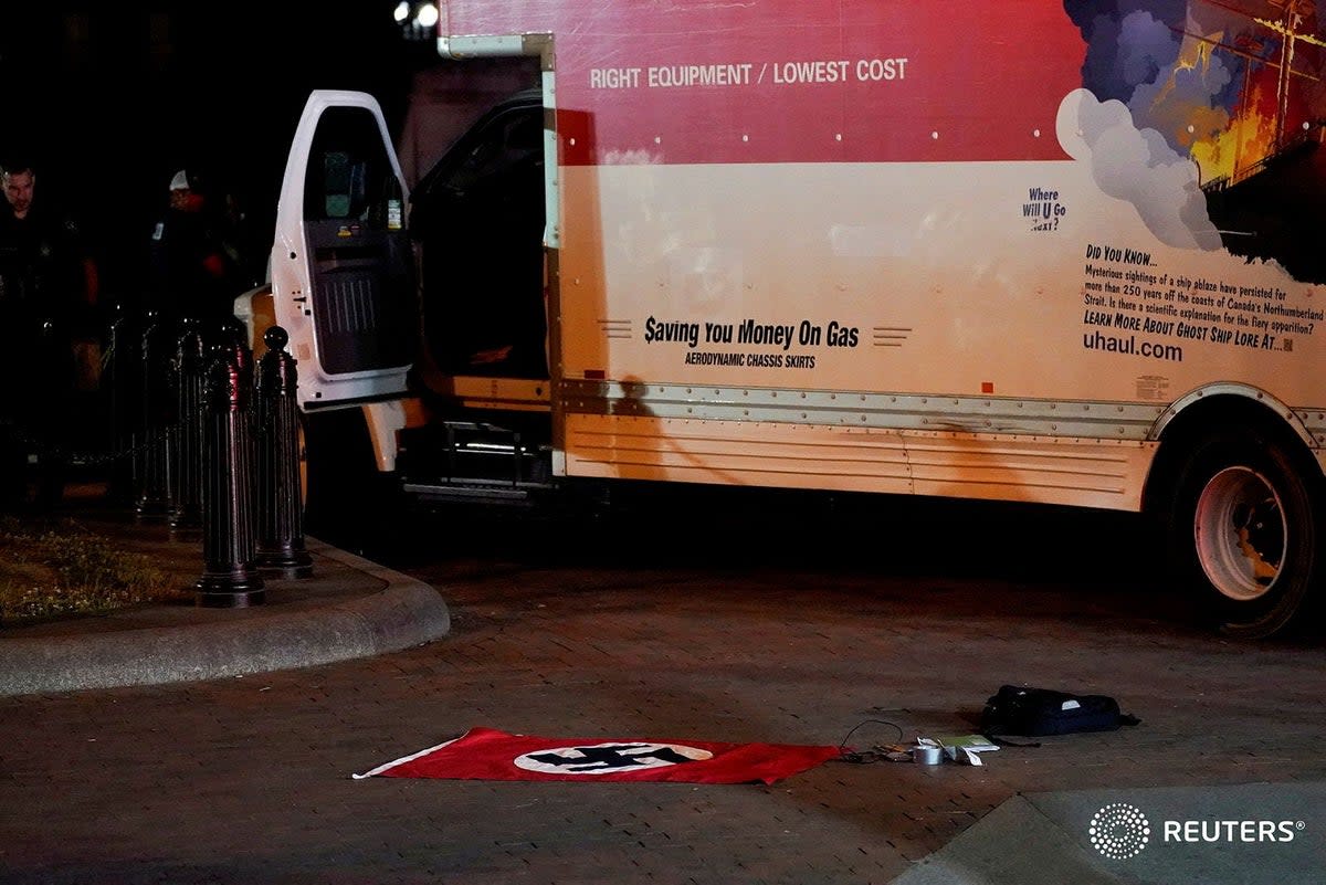 A Nazi flag is seen on the ground outside the U-haul van  (Reuters)
