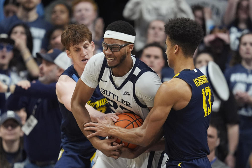 Butler's Andre Screen (23) fights for a rebound against Marquette's Ben Gold, left, and Oso Ighodaro during the second half of an NCAA college basketball game Tuesday, Feb. 13, 2024, in Indianapolis. (AP Photo/Darron Cummings)