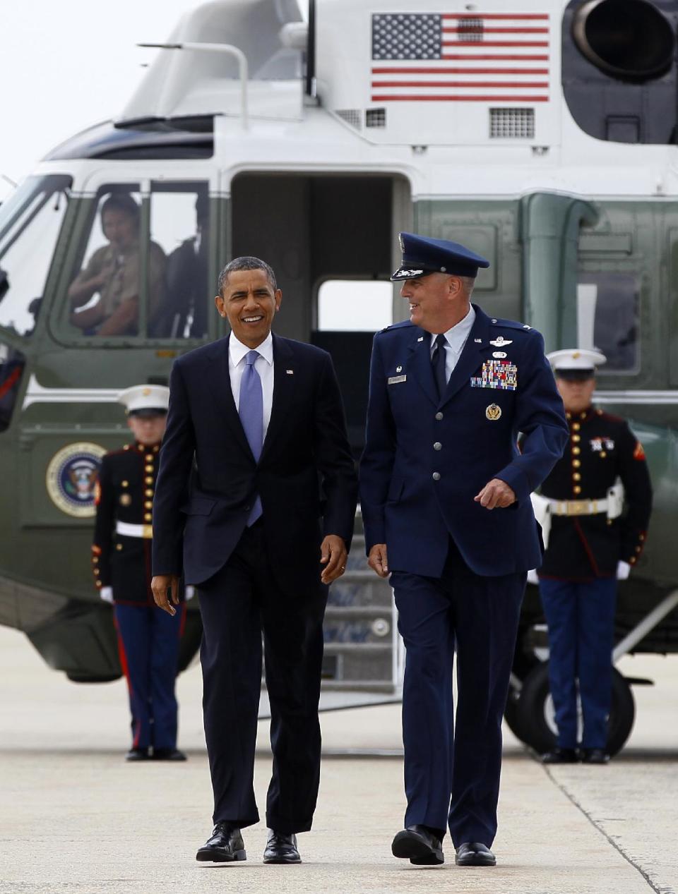 President Barack Obama walks from Marine One with Col. Michael Minihan to board Air Force One, Monday, June 25, 2012, at Andrews Air Force Base, Md., en route to New Hampshire. (AP Photo/Carolyn Kaster)