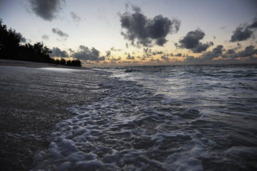 The waters of the Indian Ocean lap the shores of the low lying island of Denis in the outer banks of the Seychelles on November 24, 2009. A leaked draft of an IPCC report said that human activity is almost certainly the cause of climate change and forecast that sea levels could rise by 90 centimetres (three feet) by the end of the century,