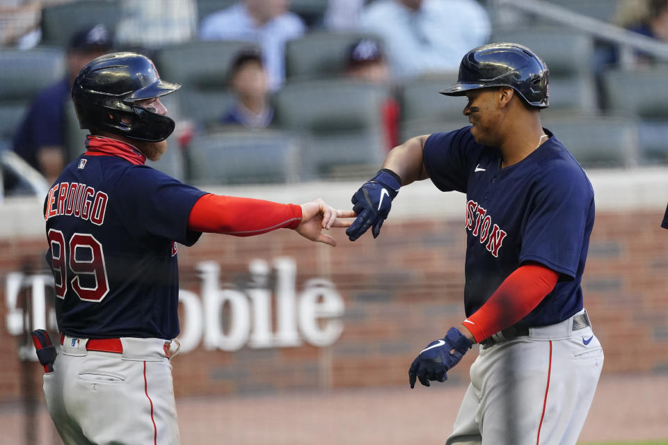 Boston Red Sox's Rafael Devers (11) celebrates with Alex Verdugo (99) after hitting a three-run home run in the first inning of a baseball game against the Atlanta Braves on Tuesday, June 15, 2021, in Atlanta. (AP Photo/John Bazemore)