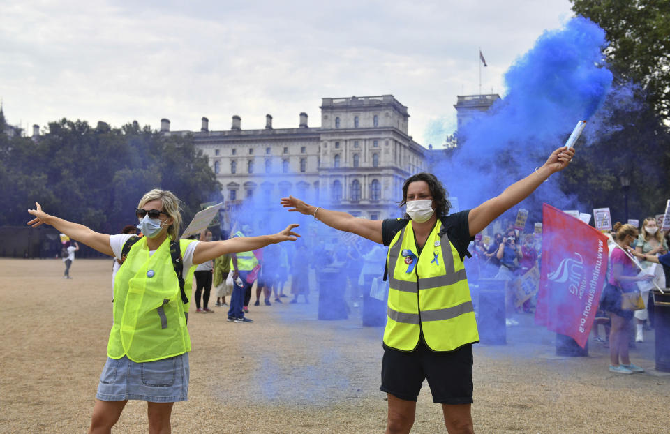 National Health Service (NHS) workers demonstrate as part of a national protest over pay, in London, Saturday Aug. 8, 2020.  Nationwide protests on Saturday are calling for government to address what they claim is many years of reduced wages, and are calling for a voice in plans for public sector pay increases. (Dominic Lipinski/PA via AP)