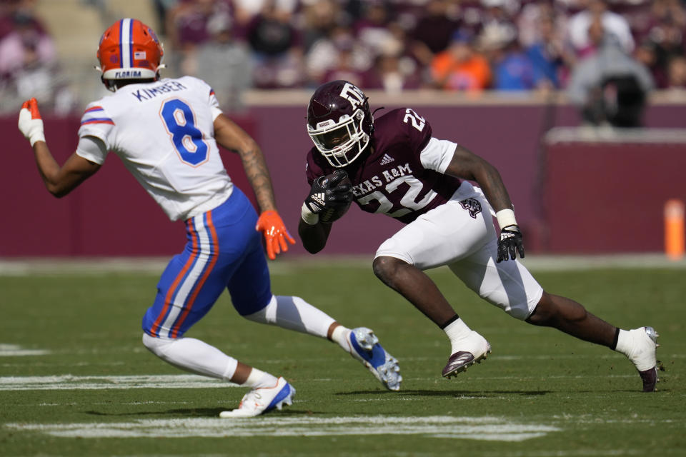Texas A&M running back Le'Veon Moss (22) tries to get to the corner as Florida cornerback Jalen Kimber (8) defends during the second quarter of an NCAA college football game Saturday, Nov. 5, 2022, in College Station, Texas. (AP Photo/Sam Craft)