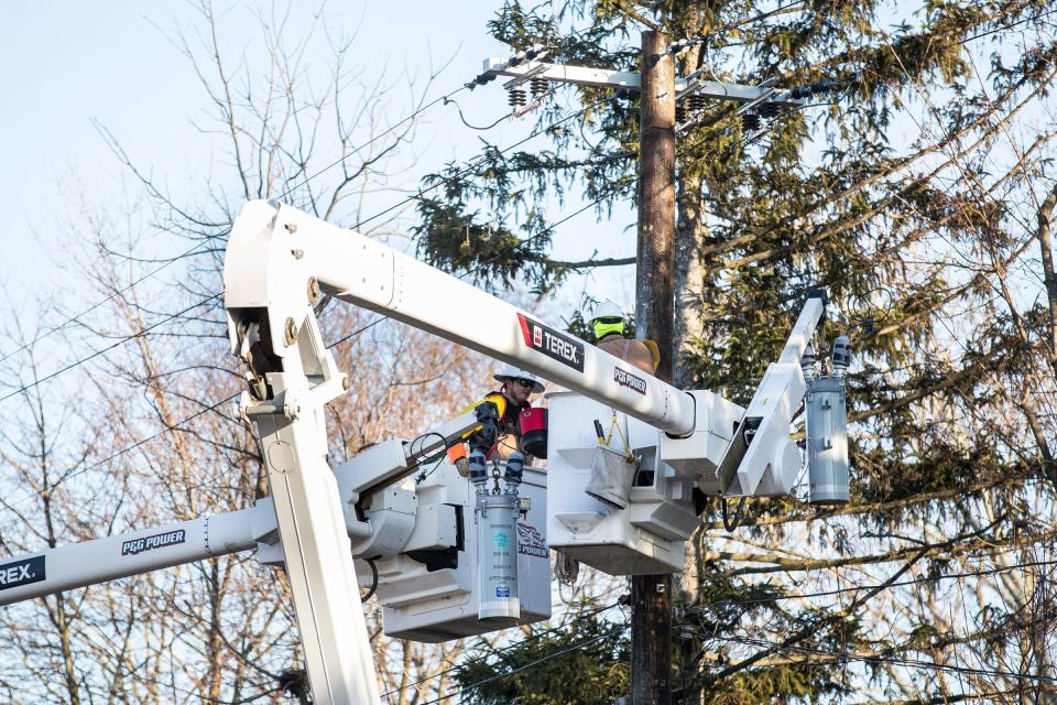 Electric workers from P&G Power prepare to replace a pair of isolating switches on Stadium Boulevard. near Brockman Boulevard in Ann Arbor on Friday, Feb. 24, 2023. Power crews are out in full force repairing and replacing downed lines that were damaged during the ice storm.