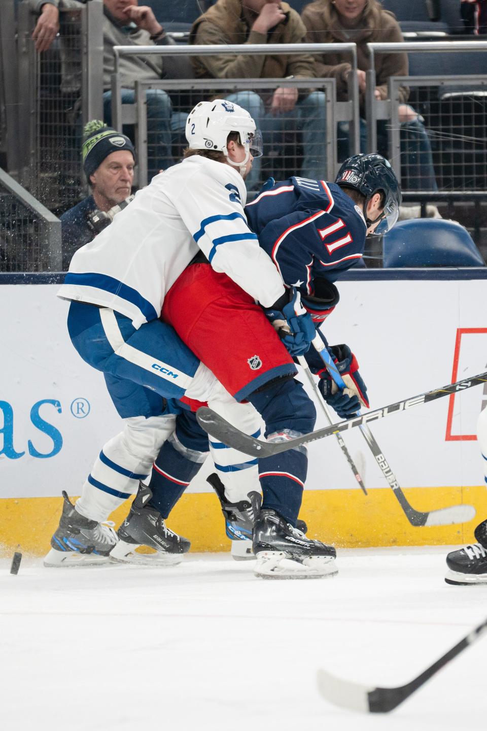 Dec 23, 2023; Columbus, Ohio, USA;
Columbus Blue Jackets center Adam Fantilli (11) and Toronto Maple Leafs defenseman Simon Benoit (2) fight for the puck during the first period of their game on Saturday, Dec. 23, 2023 at Nationwide Arena.