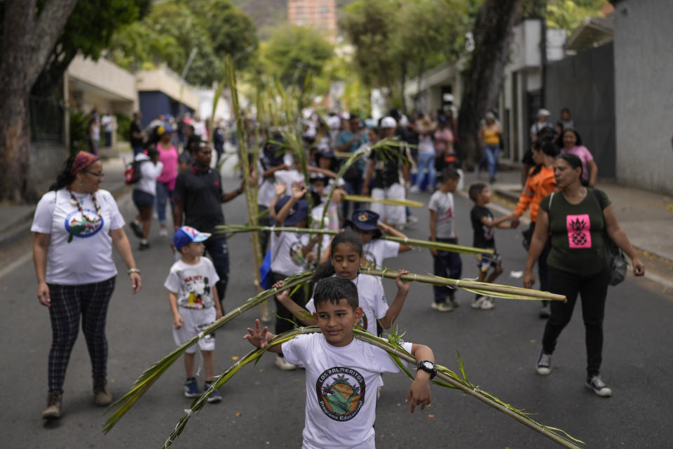 Young members of the Palmeros de Chacao brotherhood arrive with palm branches after descending the Cerro el Avila, in Caracas, Venezuela, Saturday, April 1, 2023. Every year the brothers climb the Cerro El Avila to collect the royal palm branches as part of a 250-year tradition that marks the start of Holy Week. The palms will be blessed at the Palm Sunday Mass in the Chacao church. (AP Photo/Matias Delacroix)