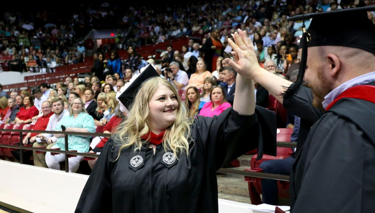 A pair of University of Alabama graduates give each other a high five Friday, May 5, 2023, at Coleman Coliseum. The university graduated more than 5,700 people in the Spring Commencement exercises.