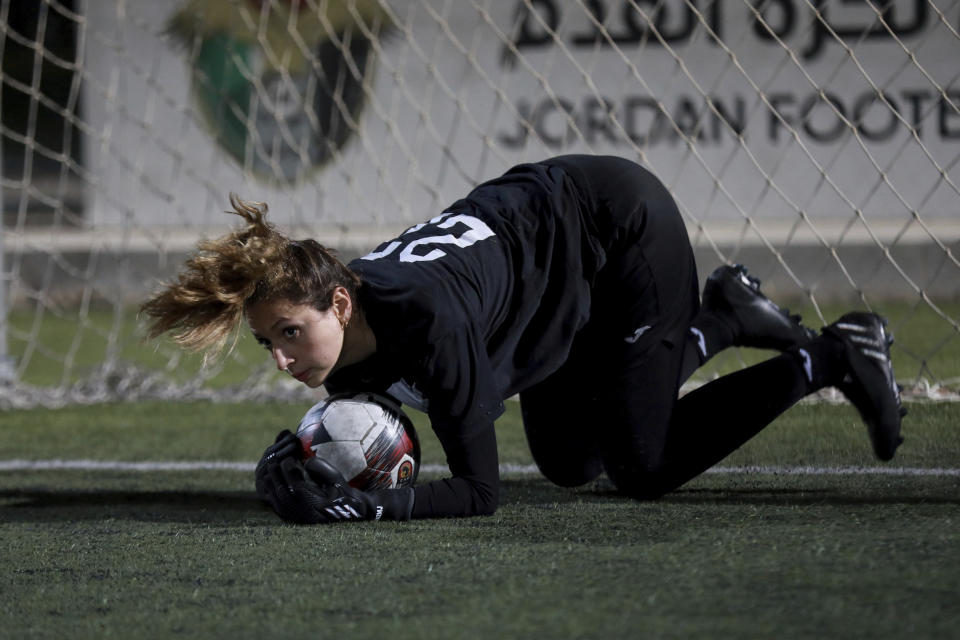 Joud Shunti, 23-year-old goalkeeper, works out during a training of the Orthodox Club's women's team in Amman, Jordan, Saturday, Oct. 22, 2022. Women's soccer has been long been neglected in the Middle East, a region that is mad for the men's game and hosts the World Cup for the first time this month in Qatar. (AP Photo/Raad AL-Adayleh)