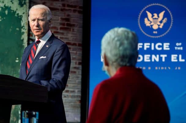 PHOTO: President-elect Joe Biden looks towards appointee for National Climate Advisor, Gina McCarthy, as he announces members of his climate and energy appointments at the Queen theater, Dec. 19, 2020, in Wilmington, Del. (Joshua Roberts/Getty Images)