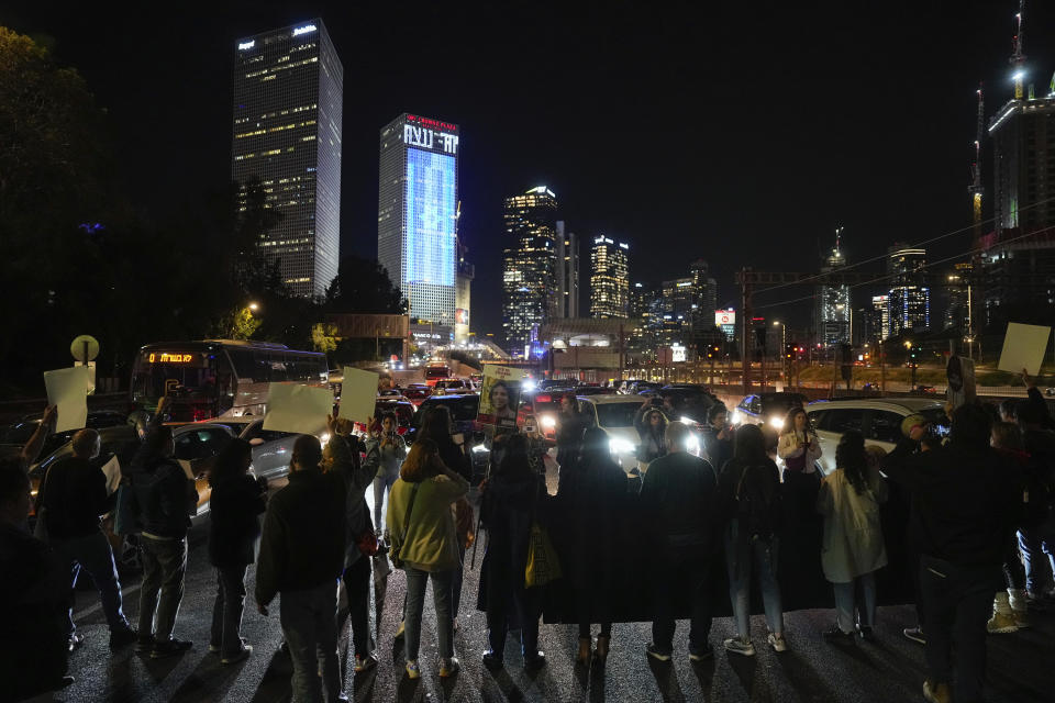 Relatives and supporters of the Israeli hostages held in the Gaza Strip by the Hamas militant group block a road during a rally calling for their release in Tel Aviv, Israel, Tuesday, March 26, 2024. (AP Photo/Ohad Zwigenberg)