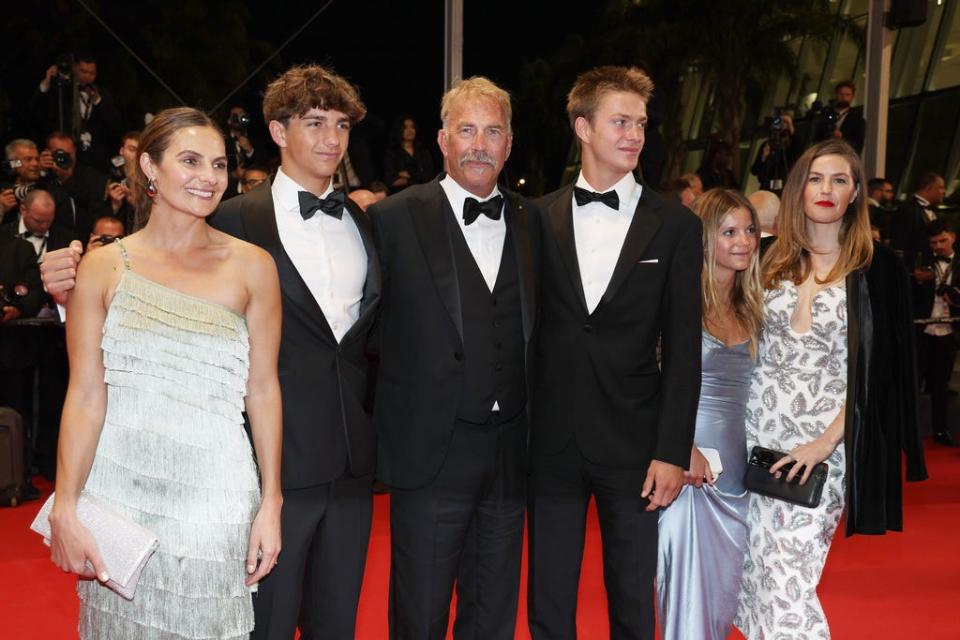 From left, Annie Costner, Hayes Costner, Kevin Costner, Cayden Costner, Grace Costner and Lily Costner depart the "Horizon: An American Saga" red carpet at the 77th annual Cannes Film Festival at Palais des Festivals on May 19, 2024, in Cannes, France.
