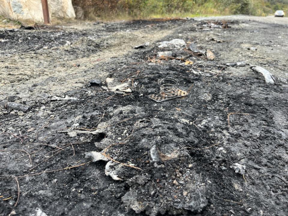 Remains of a charred vehicle can still be seen on Country Road in Bay Roberts, where human remains were found inside a pickup truck on Monday.