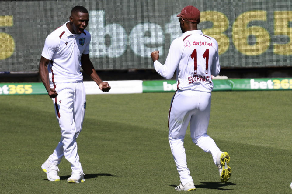 West Indies' Shamar Joseph, left, celebrates with teammate West Indies' Kraigg Brathwaite after taking the wicket of Australia's Steve Smith on the first day of their cricket test match in Adelaide, Australia, Wednesday, Jan. 17, 2024. (AP Photo/James Elsby)