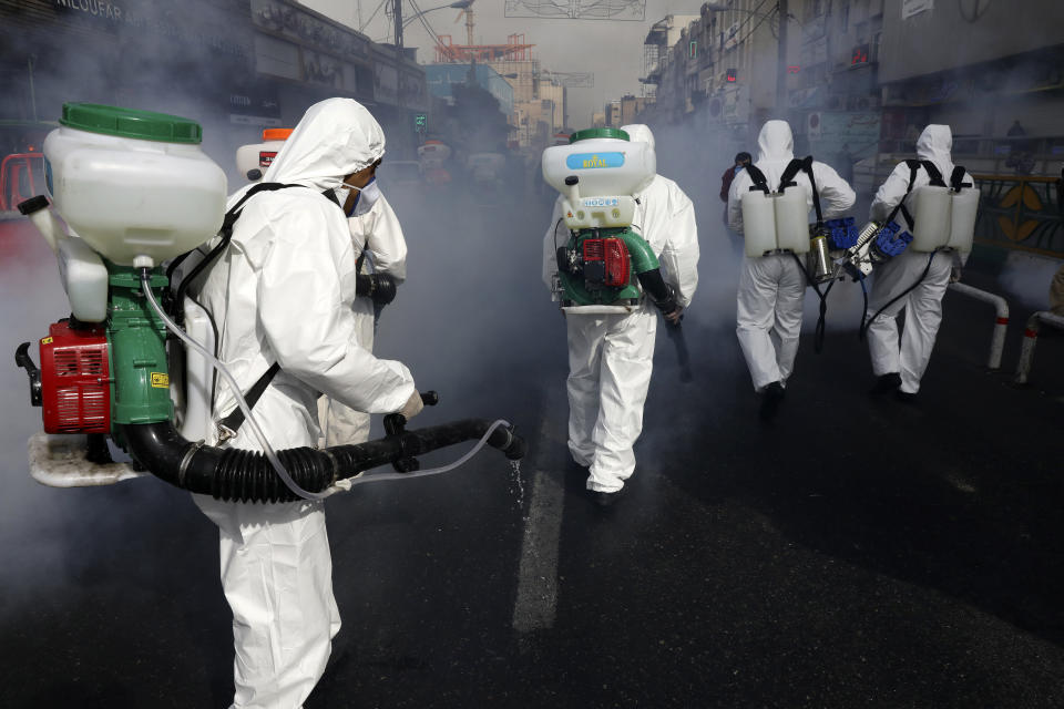 Firefighters disinfect a street against the new coronavirus, in western Tehran, Iran, Friday, March 13, 2020. The new coronavirus outbreak has reached Iran's top officials, with its senior vice president, Cabinet ministers, members of parliament, Revolutionary Guard members and Health Ministry officials among those infected. The vast majority of people recover from the new coronavirus. According to the World Health Organization, most people recover in about two to six weeks, depending on the severity of the illness. (AP Photo/Vahid Salemi)