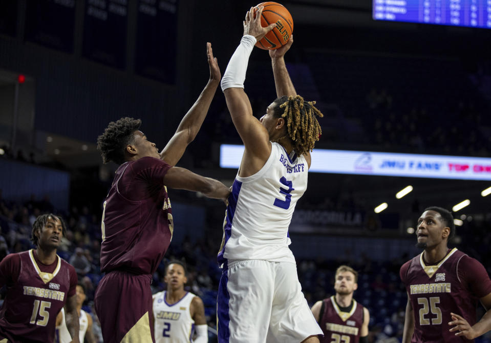 James Madison forward T.J. Bickerstaff (3) goes up for a shot against Texas State guard Josh O'Garro during the second half of an NCAA college basketball game in Harrisonburg, Va., Saturday, Dec. 30, 2023. (Daniel Lin/Daily News-Record via AP)