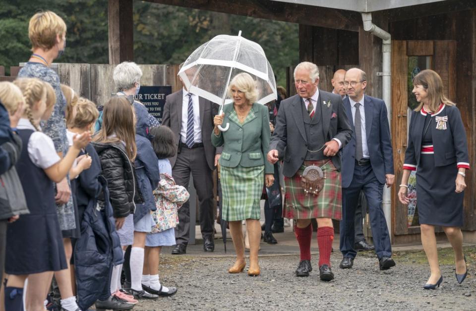 The Prince of Wales and the Duchess of Cornwall, known as the Duke and Duchess of Rothesay when in Scotland, during a visit to Alloway Main Street (Jane Barlow/PA) (PA Wire)