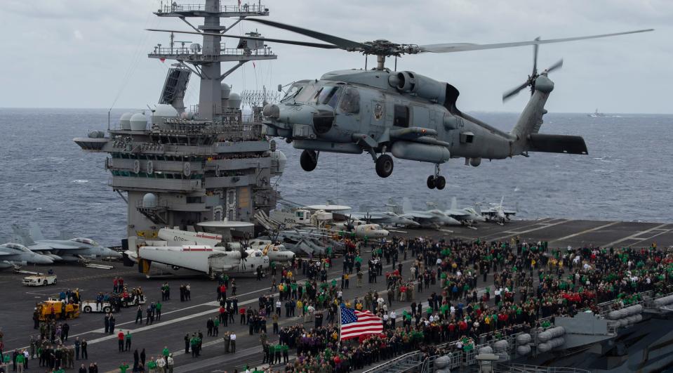 An MH-60R Sea Hawk helicopter, from the “Battlecats” of Helicopter Maritime Strike Squadron (HSM) 73, hovers above the flight deck of the aircraft carrier USS Nimitz during an air power demonstration Monday. The Nimitz and its crew have been away from families back home for more than 320 days.