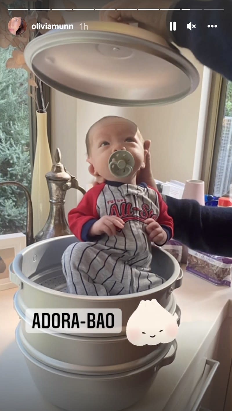 A closeup of the baby in the pot, the baby is wearing a baseball themed onesie