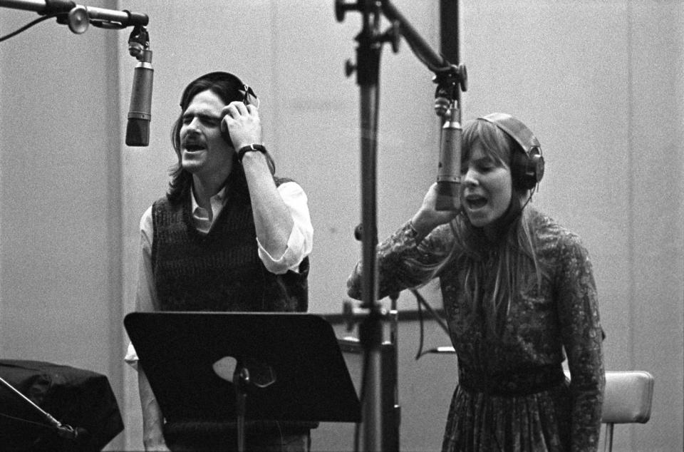 Singer-songwriters James Taylor and Joni Mitchell provide backing vocals