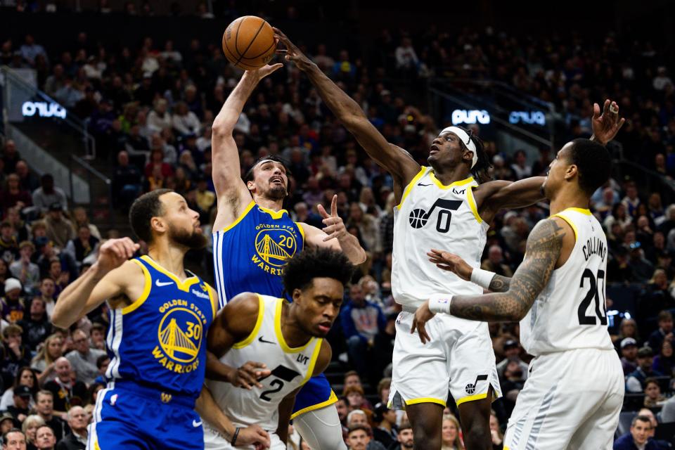 Golden State Warriors forward <a class="link " href="https://sports.yahoo.com/nba/players/5323/" data-i13n="sec:content-canvas;subsec:anchor_text;elm:context_link" data-ylk="slk:Dario Saric;sec:content-canvas;subsec:anchor_text;elm:context_link;itc:0">Dario Saric</a> (20) shoots the ball with Utah Jazz forward <a class="link " href="https://sports.yahoo.com/nba/players/10110/" data-i13n="sec:content-canvas;subsec:anchor_text;elm:context_link" data-ylk="slk:Taylor Hendricks;sec:content-canvas;subsec:anchor_text;elm:context_link;itc:0">Taylor Hendricks</a> (0) on defense during the NBA basketball game between the Utah Jazz and the Golden State Warriors at the Delta Center in Salt Lake City on Thursday, Feb. 15, 2024. | Megan Nielsen, Deseret News