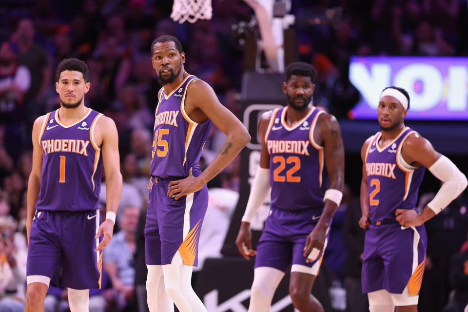 PHOENIX, ARIZONA - MARCH 29: (L-R) Devin Booker #1, Kevin Durant #35, Deandre Ayton #22 and Josh Okogie #2 of the Phoenix Suns stand on the court during a timeout from the second half of the NBA game against the Minnesota Timberwolves at Footprint Center on March 29, 2023 in Phoenix, Arizona. The Suns defeated the Timberwolves 107-100.  NOTE TO USER: User expressly acknowledges and agrees that, by downloading and or using this photograph, User is consenting to the terms and conditions of the Getty Images License Agreement.  (Photo by Christian Petersen/Getty Images)
