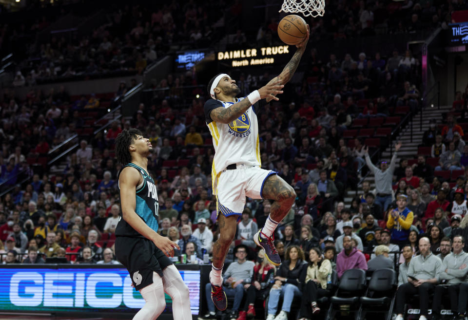 Golden State Warriors guard Gary Payton II, right, shoots in front of Portland Trail Blazers guard Shaedon Sharpe during the second half of an NBA basketball game in Portland, Ore., Sunday, April 9, 2023. (AP Photo/Craig Mitchelldyer)