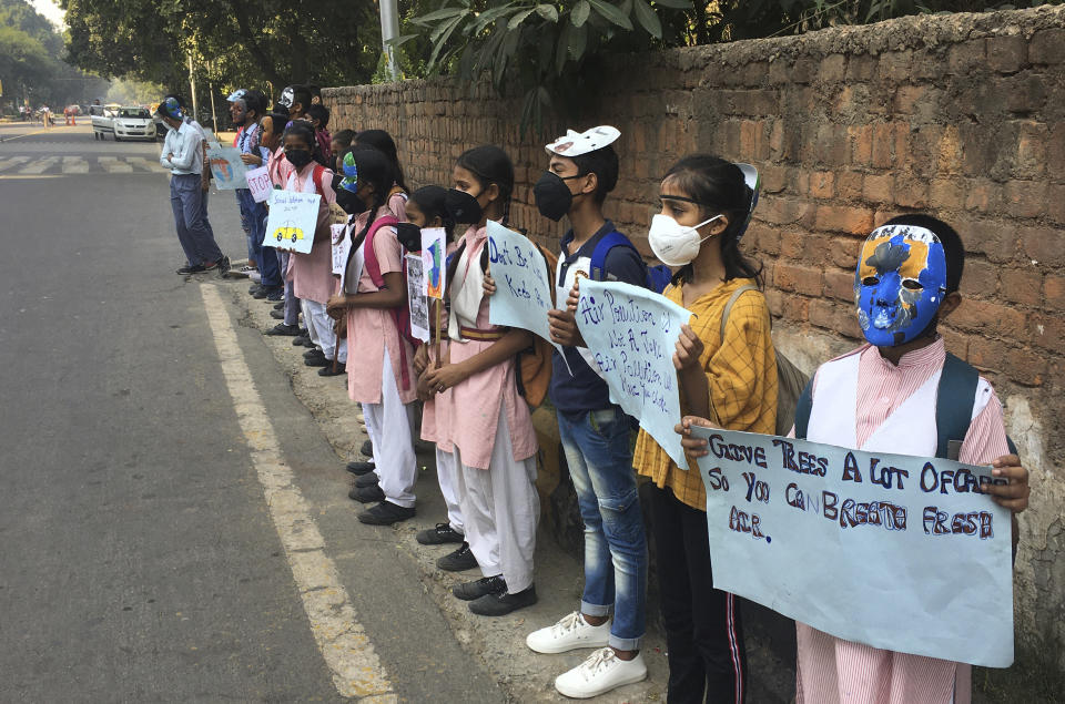 Schoolchildren protest outside the Indian Environment Ministry against alarming levels of pollution in the city, in New Delhi, India, Tuesday, Nov. 5, 2019. Air pollution in New Delhi and northern Indian states peaks in the winter as farmers in neighboring agricultural regions set fire to clear land after the harvest and prepare for the next crop season. The pollution in the Indian capital also peaks after Diwali celebrations, the Hindu festival of light, when people set off fireworks. (AP Photo/Shonal Ganguly)