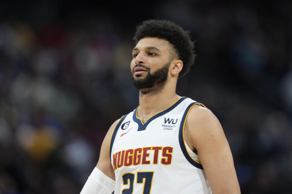 Denver Nuggets guard Jamal Murray looks on during a break in the action in the first half of an NBA basketball game against the Chicago Bulls Wednesday, March 8, 2023, in Denver. (AP Photo/David Zalubowski)