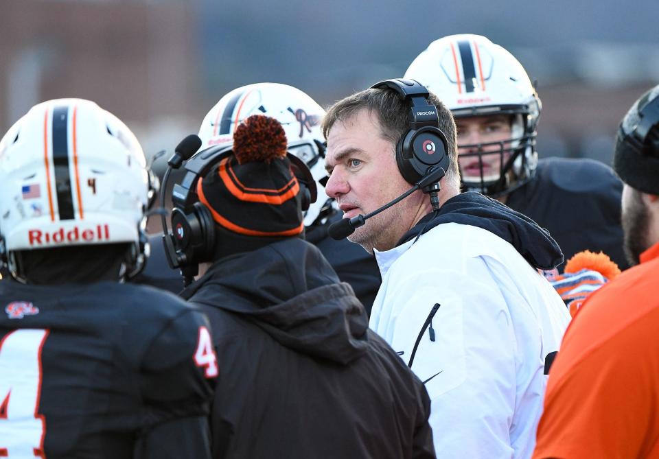 Cathedral Prep head coach Mike Mishler, center, and his team take a moment to discuss strategy during a timeout late in the 2nd quarter on Saturday.