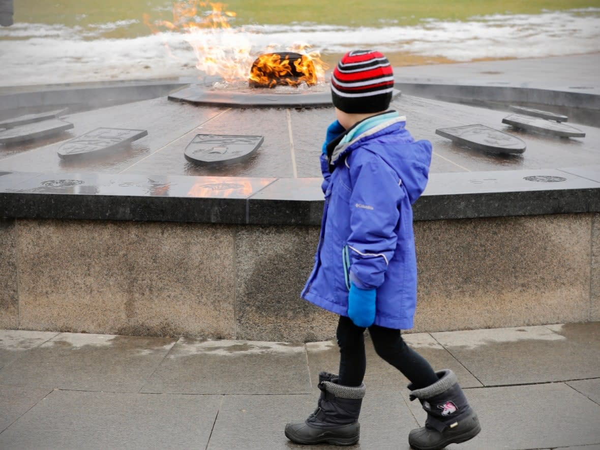 A child looks at the Centennial Flame on Parliament Hill in Ottawa Jan. 3, 2023. (Christian Patry/CBC - image credit)