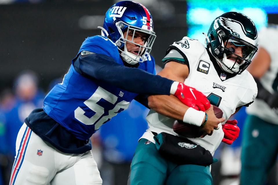 New York Giants linebacker Bobby Okereke (58) goes after Philadelphia Eagles quarterback Jalen Hurts (1) just before sacking him in the second quarter, Sunday, January 7, 2024.