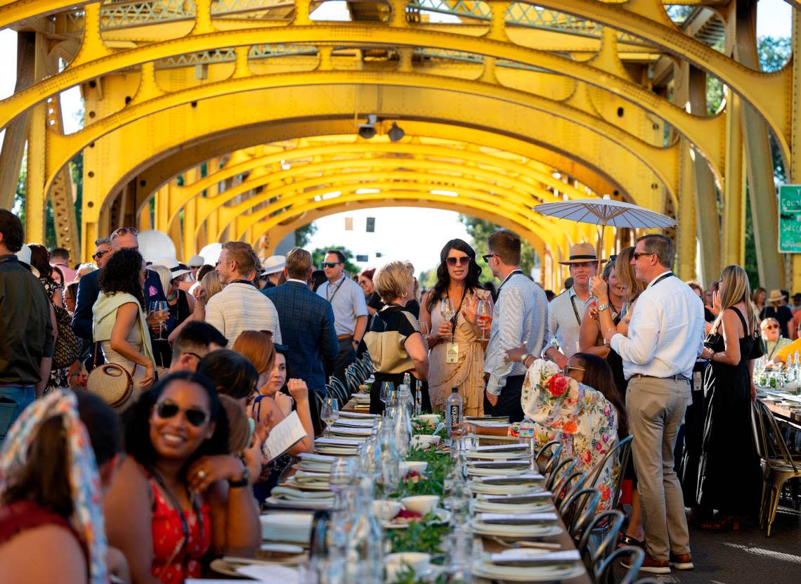 Guests talk before the start of the Farm-to-Fork’s Tower Bridge Dinner on Sunday.