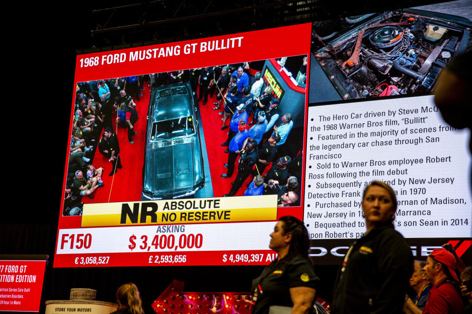 This photo shows a sign describing the 1968 Ford Mustang "Bullitt," car during the Mecum Kissimmee auction, Friday, Jan 10, 2020 in Kissimmee, Fla. The iconic Highland Green 1968 Mustang GT that once made history for its appearance in the film “Bullitt” is now making history again. It fetched $3.74 million Friday at Mecum’s Kissimmee auction, making it the most expensive Mustang ever sold. (Patrick Connolly/Orlando Sentinel via AP)