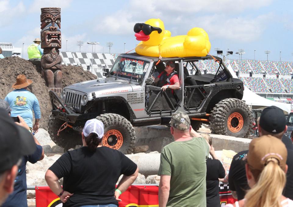 Jeep Beach fans watch a duck-adorned vehicle take on the obstacle course on Friday at the Jeep Beach &#39;Main Event&#39; at Daytona International Speedway. Area hoteliers praise the event for its positive impact on tourism and the community.