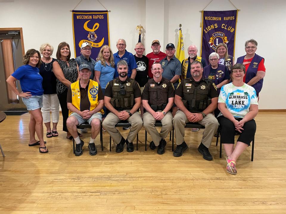 Members of the Wood County Sheriff's Office, the Wisconsin Rapids Lions Club and Bluegrass at the Lake pose for a picture after celebrating a $12,800 check given to the Wood County Critical Incident Stress Management Team.