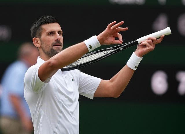 Novak Djokovic pretends to play his racket like a violin