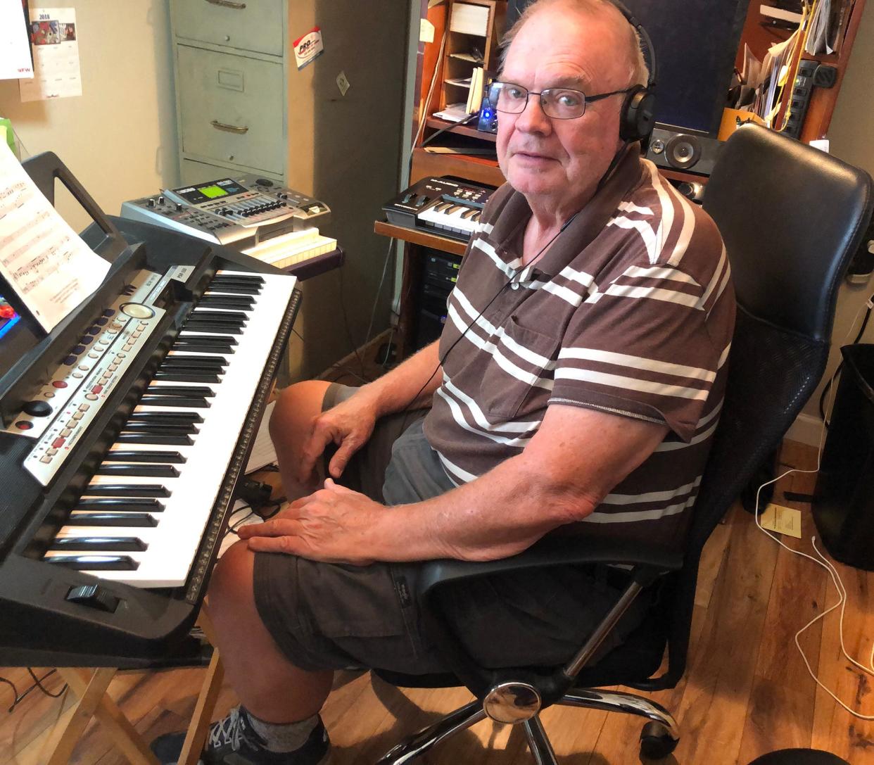 Mike Fisher sits in his home studio where he composed his latest work, 'The Missing Link.' He will perform and record the music with a string quartet at 2 p.m.  Wednesday, Aug. 3, at Watson Hall on the University of North Carolina School of the Arts campus in Winston-Salem.