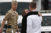 A woman weeps as she is reunited with her husband, who was one of hundreds of Navy Yard workers evacuated to a makeshift Red Cross shelter after a shooting, at the Nationals Park baseball stadium near the affected naval installation in Washington, September 16, 2013. (REUTERS/Jonathan Ernst)