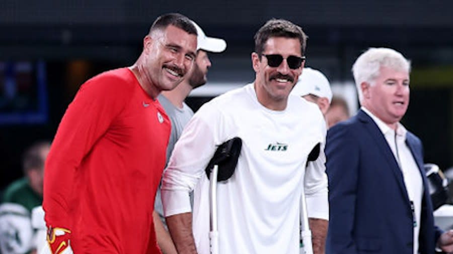 Travis Kelce #87 of the Kansas City Chiefs talks with injured Aaron Rodgers #8 of the New York Jets prior to the game at MetLife Stadium on October 01, 2023 in East Rutherford, New Jersey. (Photo by Dustin Satloff/Getty Images)