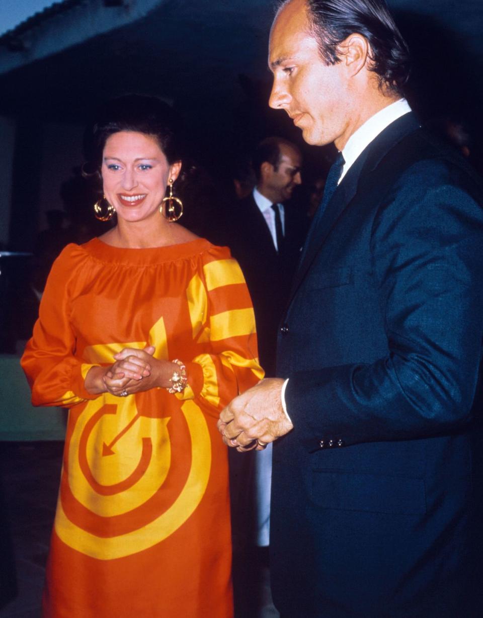 <p>Princess Margaret wears an orange and yellow with the Aga Khan, at his vacation resort in August, 1967.</p>