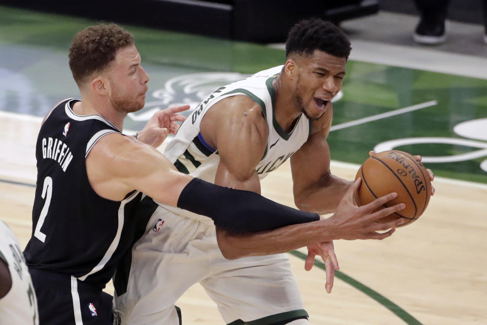 Milwaukee Bucks' Giannis Antetokounmpo is fouled by Brooklyn Nets' Blake Griffin during the second half of an NBA basketball game Tuesday, May 4, 2021, in Milwaukee. (AP Photo/Aaron Gash)